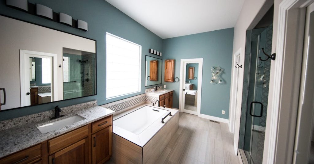 Spacious modern bathroom featuring a freestanding bathtub, wooden cabinets, and granite countertops.