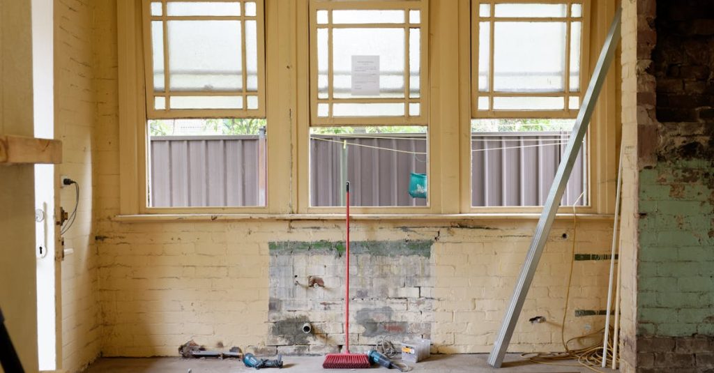 An empty room featuring large windows, ready for renovation in Sydney, Australia.