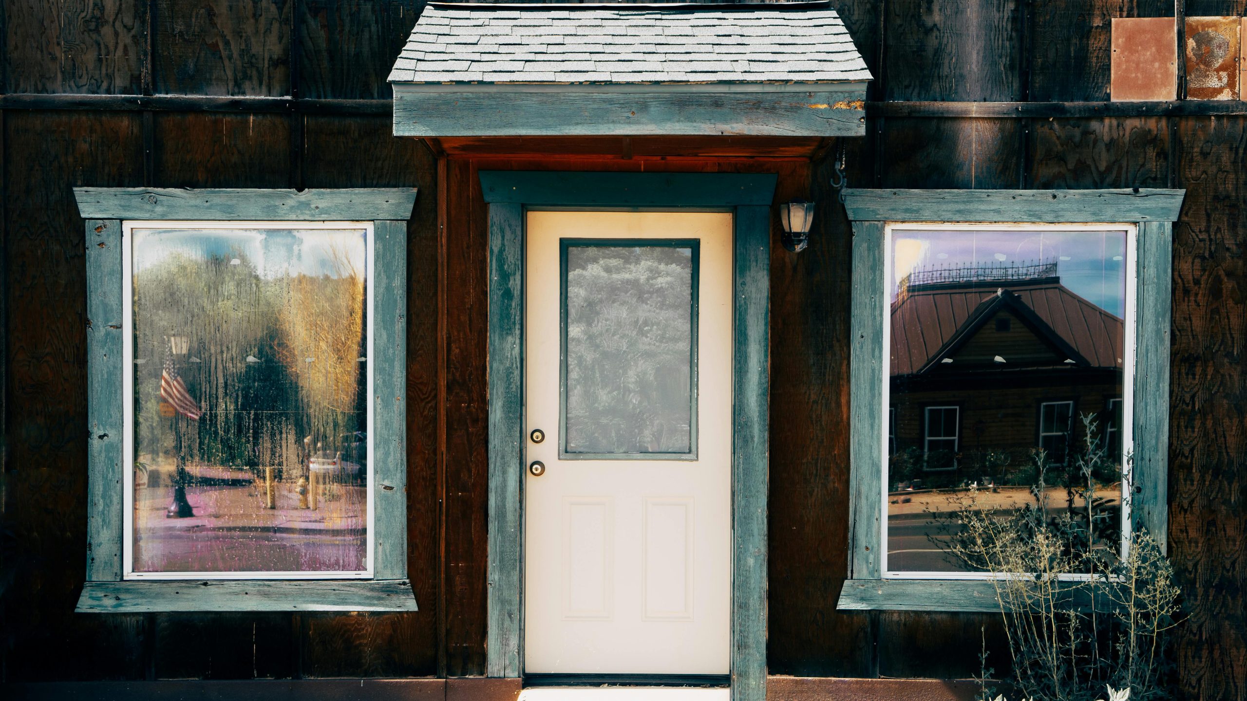 Vintage wooden facade with central door and windows, reflecting scenic views in Payson, AZ.